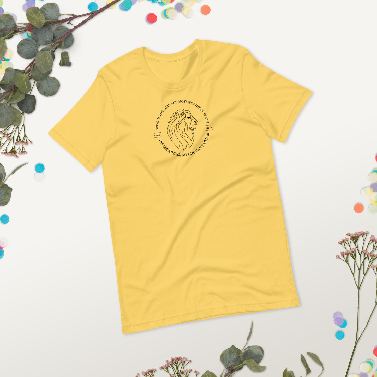 Yellow t-shirt with a lion graphic and text on a light gray background with decorative elements.